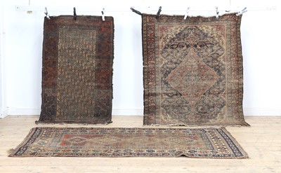 Lot 309 - Three well-worn country house rugs