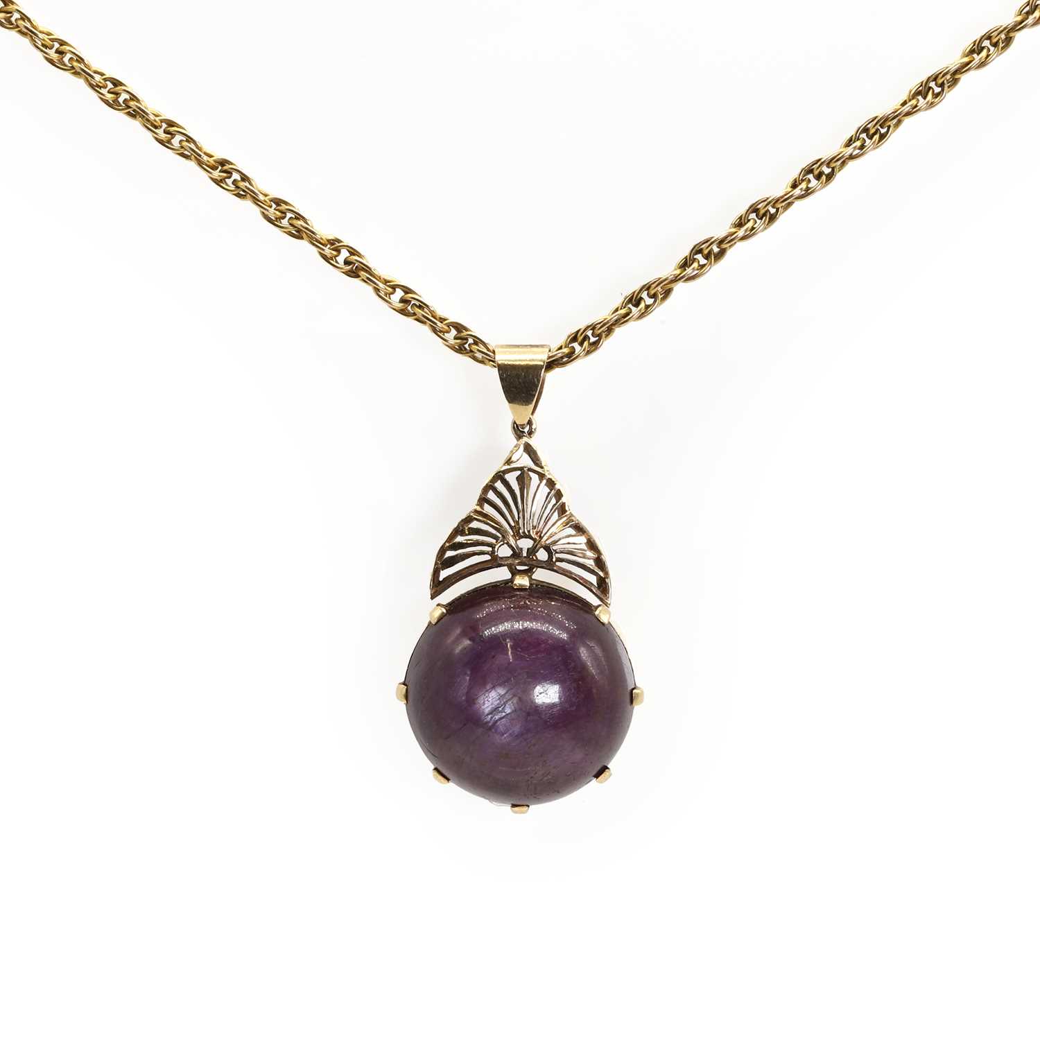 Lot 87 - A large purplish red star ruby pendant and chain