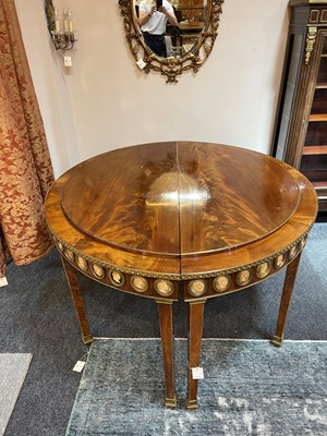 Lot 554 - A pair of neoclassical mahogany and ormolu pier tables