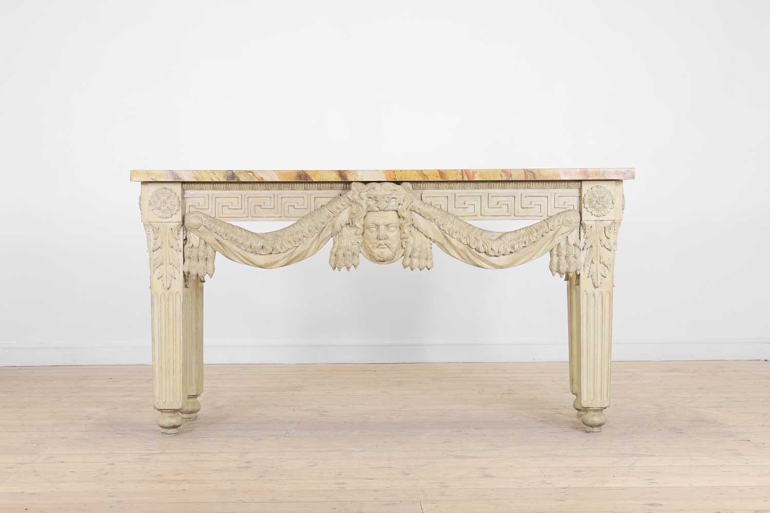 Lot A George II-style carved and painted pine console table in the manner of William Kent