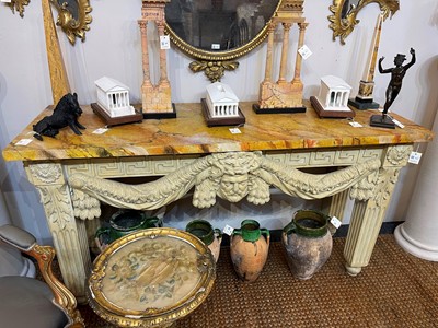 Lot 573 - A George II-style carved and painted pine console table in the manner of William Kent