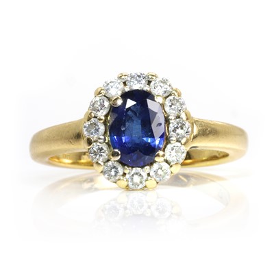 Lot 115 - An 18ct gold sapphire and diamond cluster ring