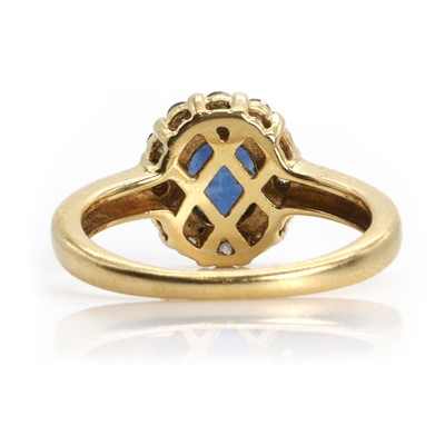 Lot 115 - An 18ct gold sapphire and diamond cluster ring