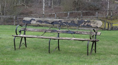 Lot 569 - A wooden and wrought iron garden bench