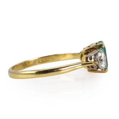 Lot 180 - An 18ct gold Colombian emerald and diamond three stone ring