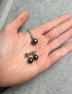 Lot 155 - An 18ct white gold black pearl necklace and black pearl stud earrings by Mikimoto
