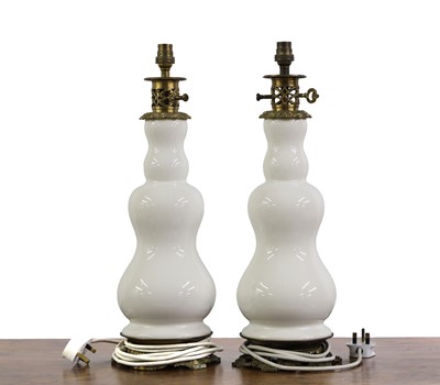 Lot 503 - A pair of earthenware and brass mounted table lamps