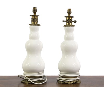 Lot 513 - A pair of earthenware and brass mounted table lamps