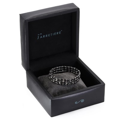 Lot 149 - A white gold diamond and black ceramic bead bracelet, by Jarretiere