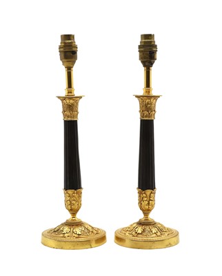 Lot 319 - A pair of ormolu and bronze candlesticks