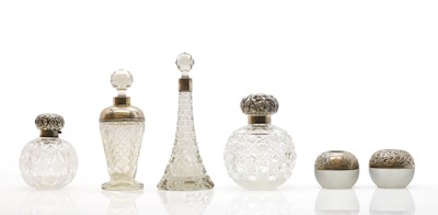 Lot 45 - A collection of silver mounted glass scent bottles
