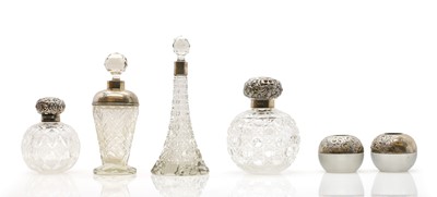 Lot 45 - A collection of silver mounted glass scent bottles