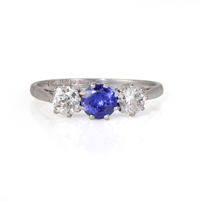 Lot 187 - A white gold diamond and sapphire three stone ring