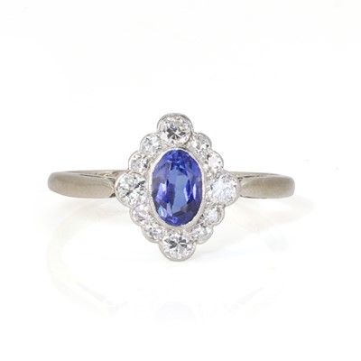 Lot 186 - A white gold synthetic sapphire and diamond cluster ring