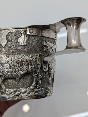Lot 23 - A silver repousse mug