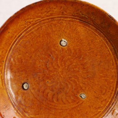 Lot 6 - A Chinese amber-glazed saucer