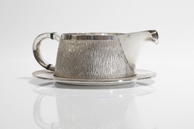 Lot 132 - A textured sterling silver cream jug