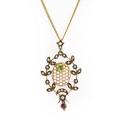 Lot 52 - A Belle Époque peridot, ruby and split pearl openwork pendant