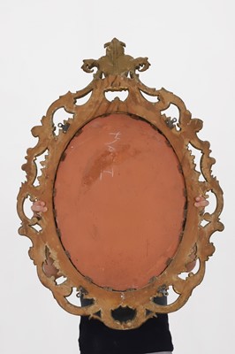 Lot 83 - A carved giltwood oval mirror