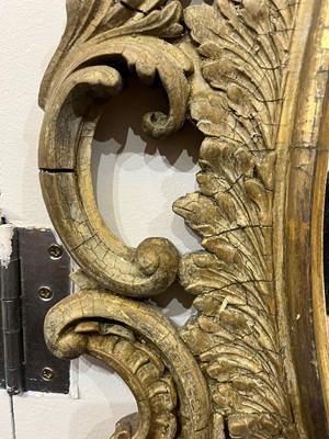 Lot 83 - A carved giltwood oval mirror
