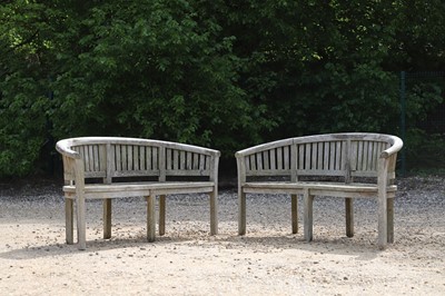 Lot 98 - A pair of curved teak garden benches
