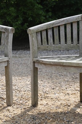 Lot 98 - A pair of curved teak garden benches