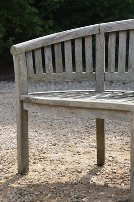 Lot 98 - A pair of curved teak garden benches