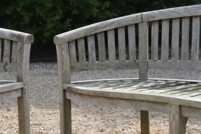 Lot 98 - A pair of curved teak garden benches