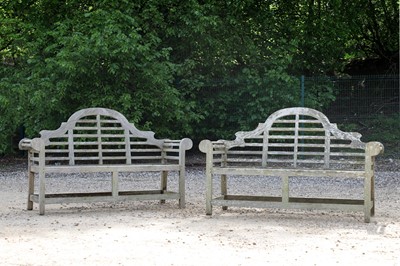 Lot 96 - A pair of teak garden benches in the manner of Edwin Lutyens