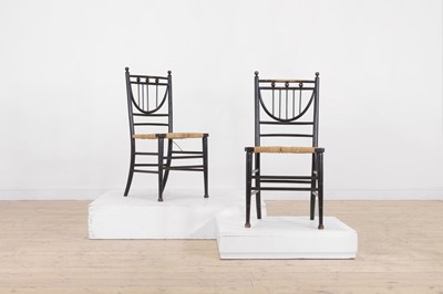 Lot 75 - A pair of ebonised wooden side chairs