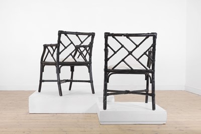 Lot 26 - A pair of ebonised bamboo ‘cockpen’ elbow chairs