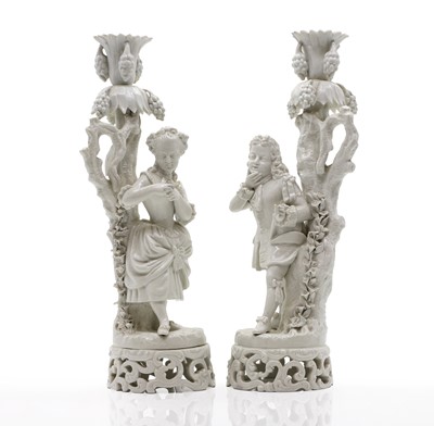 Lot 219 - A pair of Dresden 'blanc de chine' figural candlesticks