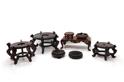 Lot 212 - A collection of eight Chinese wood stands