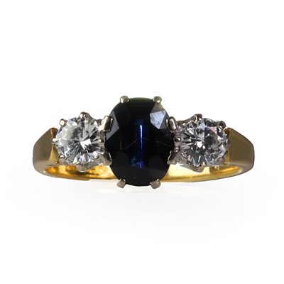 Lot 138 - An 18ct gold diamond and sapphire three stone ring