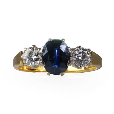 Lot 181 - An 18ct gold diamond and sapphire three stone ring