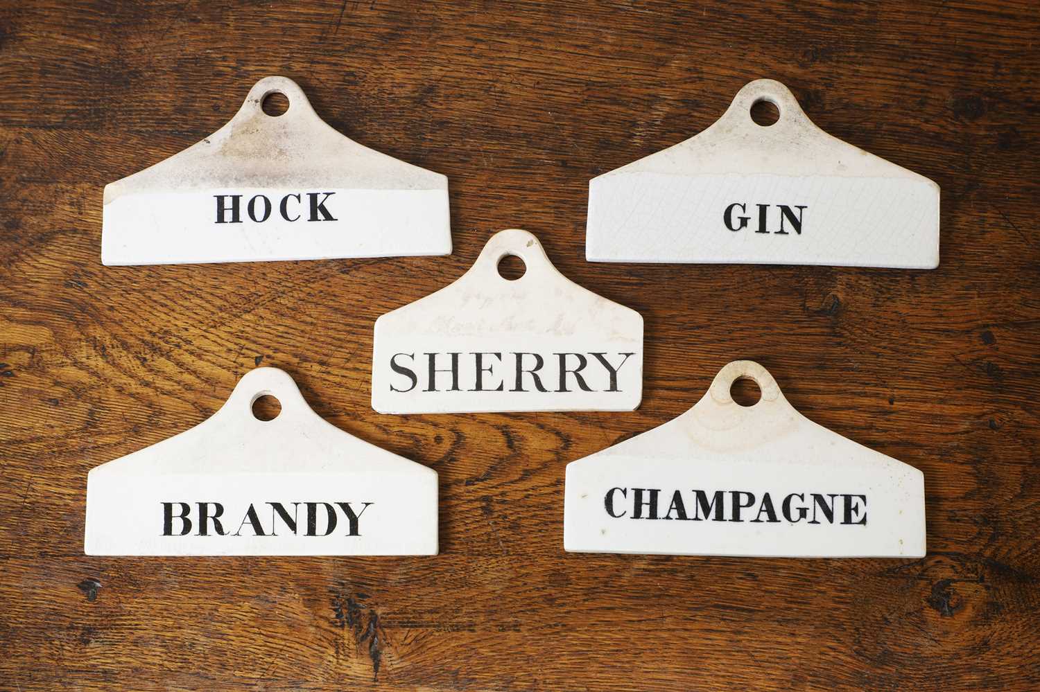 Lot 130 - A group of five ceramic wine bin labels