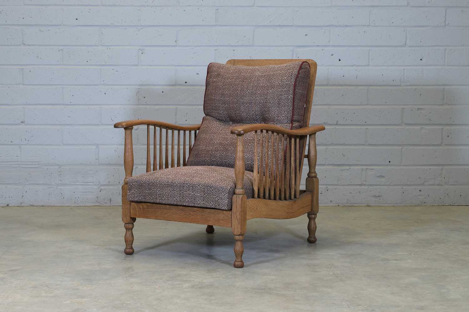 Lot 140 - An Arts and Crafts Patent oak armchair