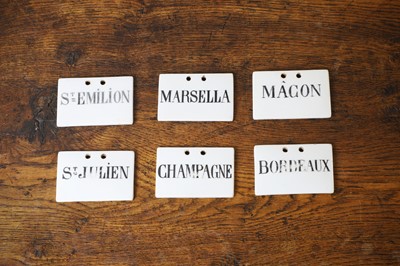Lot 134 - A matched set of six ceramic wine bin labels