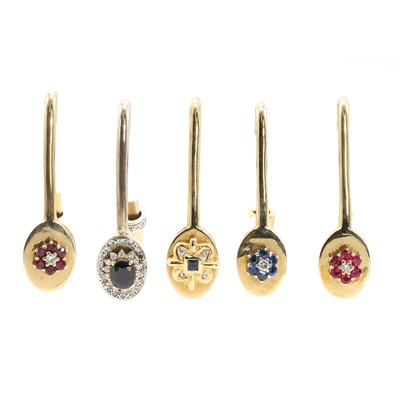 Lot 363 - A group of five gold and gem set napkin clips