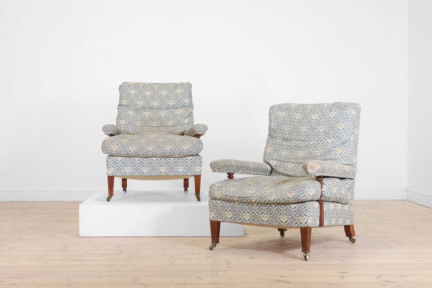 Lot A pair of open armchairs by Howard & Sons