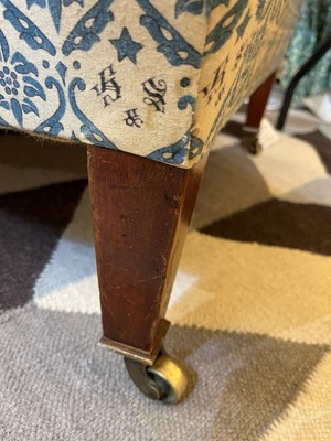 Lot 104 - A pair of open armchairs by Howard & Sons