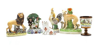 Lot 94 - A collection of Staffordshire pottery figures