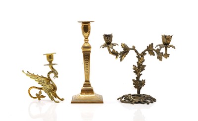 Lot 143 - A collection of four brass candlesticks