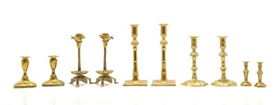 Lot 142 - Five pairs of brass candlesticks