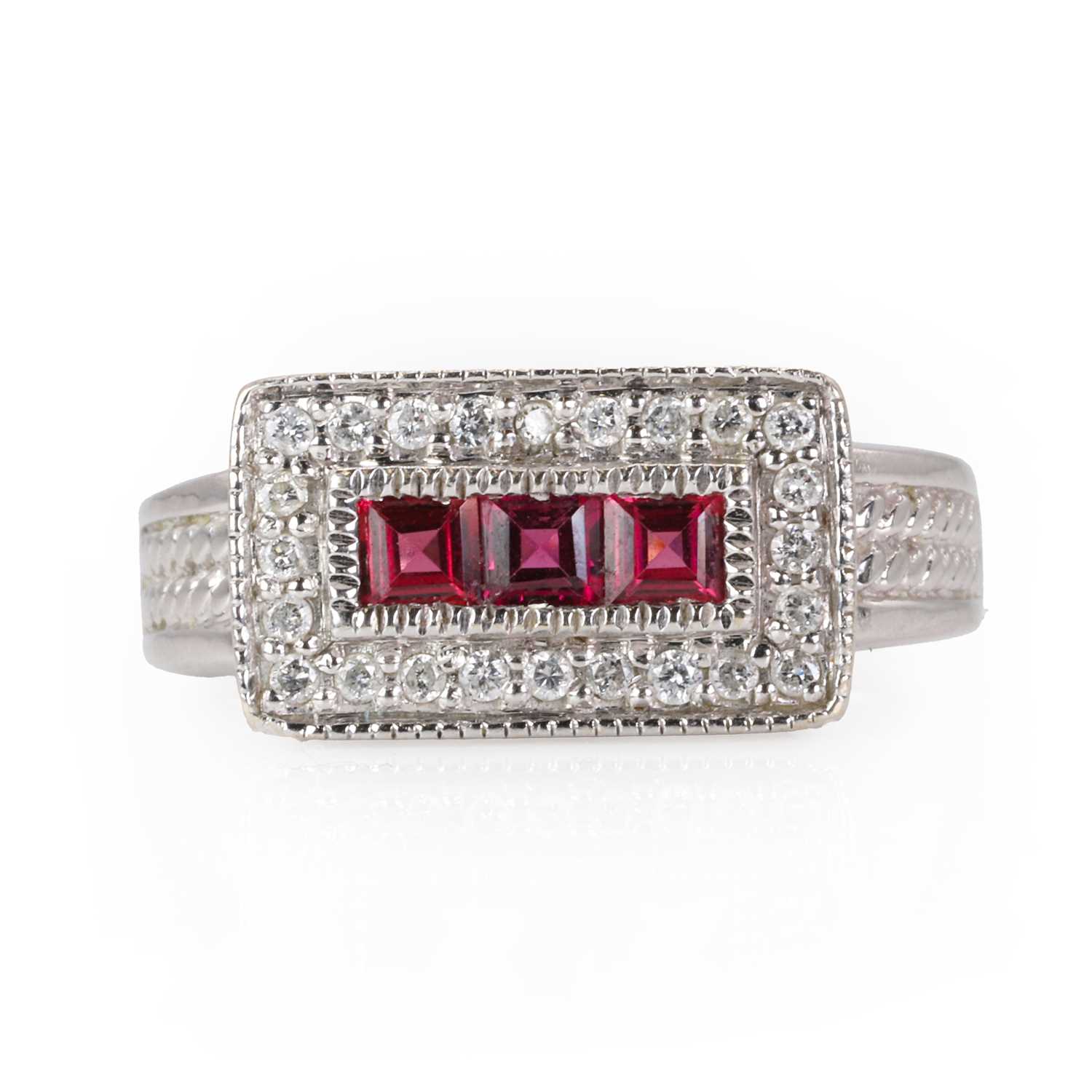 Lot 233 - A white gold diamond and rhodolite garnet ring