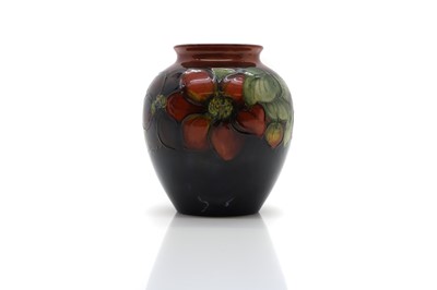 Lot 186 - A Walter Moorcroft pottery 'Clematis' pattern vase