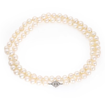 Lot 214 - A single row uniform cultured pearl necklace with a diamond set clasp