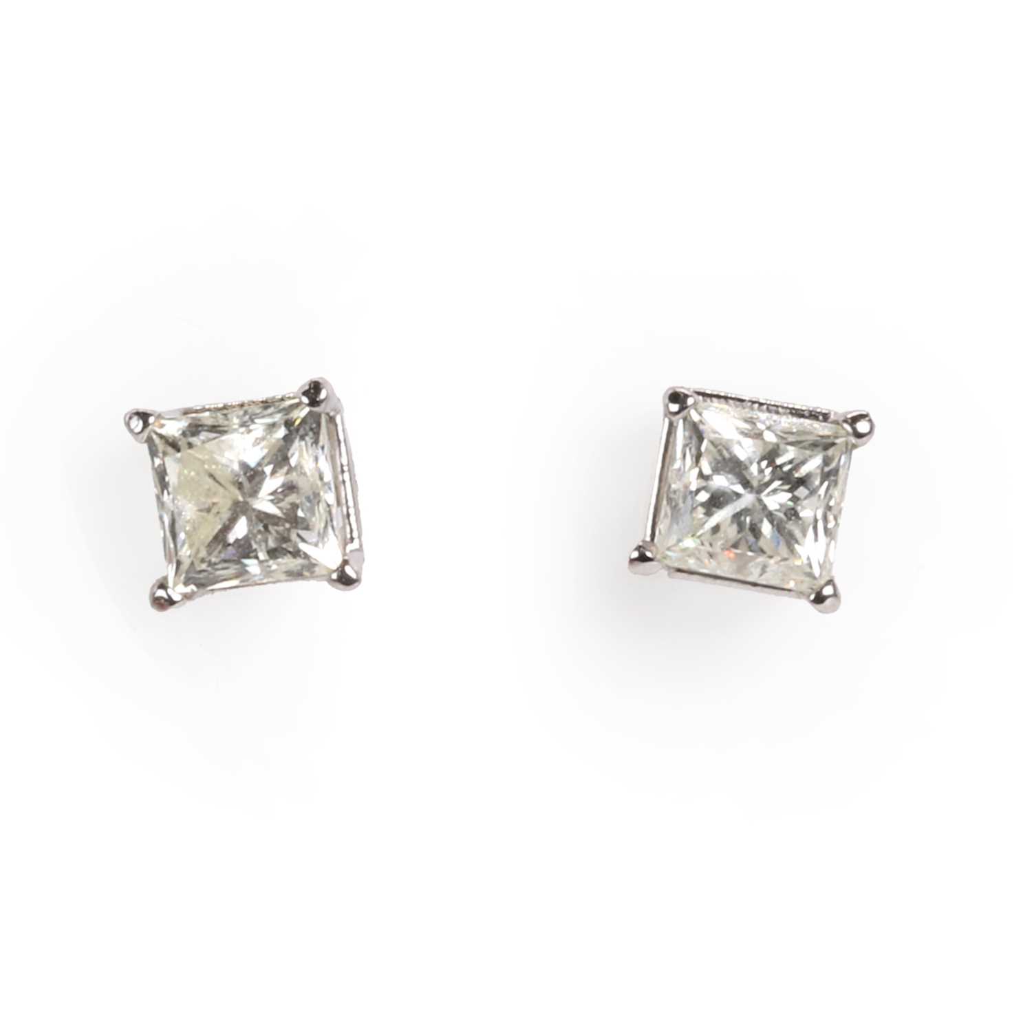 Lot 221 - A pair of princess cut diamond stud earrings