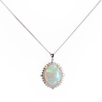 Lot 153 - An oval cabochon opal and diamond cluster pendant