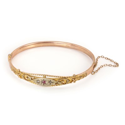 Lot 46 - A 9ct gold ruby and rose cut diamond bangle